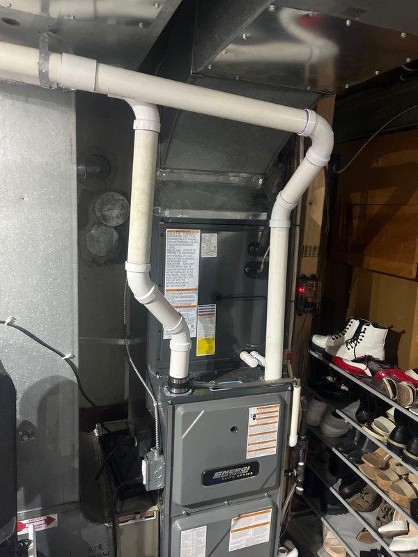 Completed full HVAC system replacement including outdoor condensing unit and indoor air handler/furnace. Installed new AC condenser on existing concrete pad with proper gravel base, ensuring level placement and adequate clearance from structure. Unit features protective top grille and proper ventilation louvers. Connected refrigerant lines using insulated line set with black corrugated protective covering. Installed matching indoor furnace unit in mechanical closet with complete PVC condensate drainage system and venting configuration. Verified all manufacturer labels and safety documentation properly affixed to equipment. Tested system operation, confirmed proper airflow, checked refrigerant charge levels, and verified all electrical connections meet code requirements. System operational and performing to manufacturer specifications.