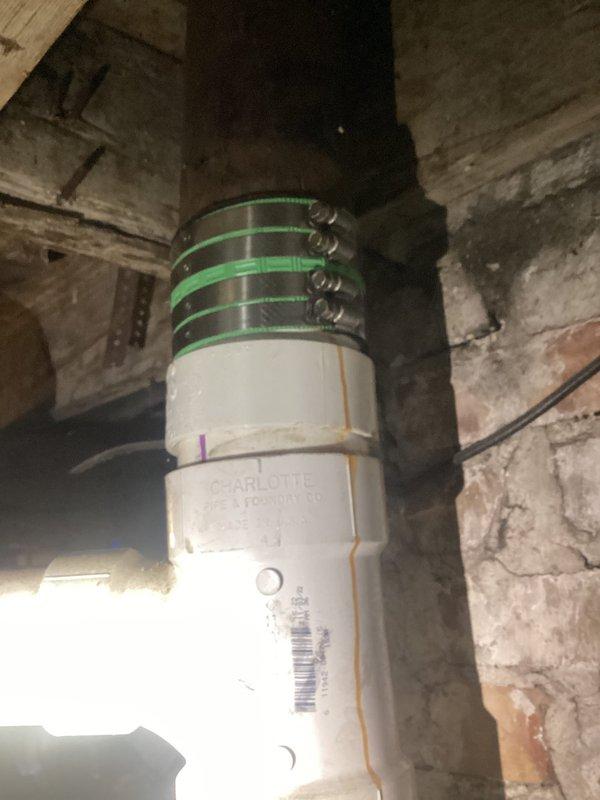 Responded to plumbing leak in basement main drain pipe. Upon inspection, identified leakage occurring at multiple joints along a vertical white PVC drain line that had been previously installed. The pipe was secured to a wooden support post using metal hose clamps. Applied repairs to the leaking joints to restore proper seal and prevent further water discharge. Documented existing conditions and completed repairs with photo verification.