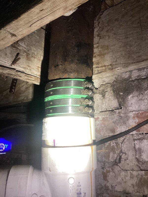 Responded to plumbing leak in basement main drain pipe. Upon inspection, identified leakage occurring at multiple joints along a vertical white PVC drain line that had been previously installed. The pipe was secured to a wooden support post using metal hose clamps. Applied repairs to the leaking joints to restore proper seal and prevent further water discharge. Documented existing conditions and completed repairs with photo verification.