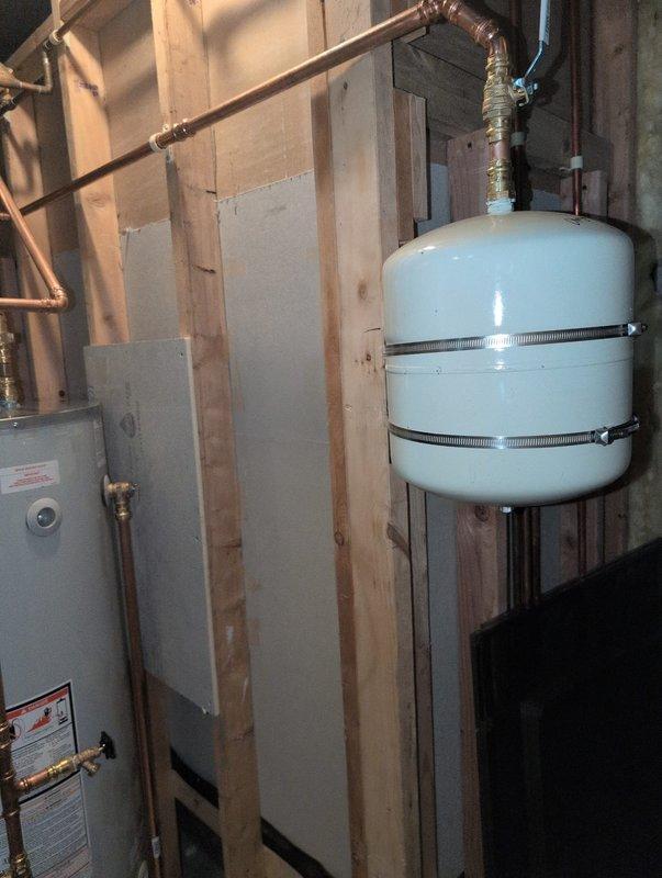 Responded to inspector correction regarding water heater venting that exceeded allowable bend limits per Table G2428.2. The original installation contained six 90-degree bends and two 45-degree bends, which significantly reduced vent capacity beyond code-compliant parameters (maximum of two 90-degree bends allowed, with 10% capacity reduction per additional 90-degree bend and 5% per 45-degree bend). Reconfigured the venting system to eliminate excess bends and ensure proper vent capacity in accordance with manufacturer specifications and applicable building codes. Verified all connections, secured ductwork, and confirmed proper clearances around water heater and expansion tank. Installation now meets code requirements for safe and efficient operation.