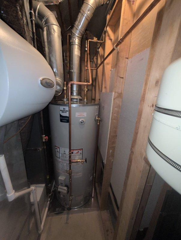 Responded to inspector correction regarding water heater venting that exceeded allowable bend limits per Table G2428.2. The original installation contained six 90-degree bends and two 45-degree bends, which significantly reduced vent capacity beyond code-compliant parameters (maximum of two 90-degree bends allowed, with 10% capacity reduction per additional 90-degree bend and 5% per 45-degree bend). Reconfigured the venting system to eliminate excess bends and ensure proper vent capacity in accordance with manufacturer specifications and applicable building codes. Verified all connections, secured ductwork, and confirmed proper clearances around water heater and expansion tank. Installation now meets code requirements for safe and efficient operation.