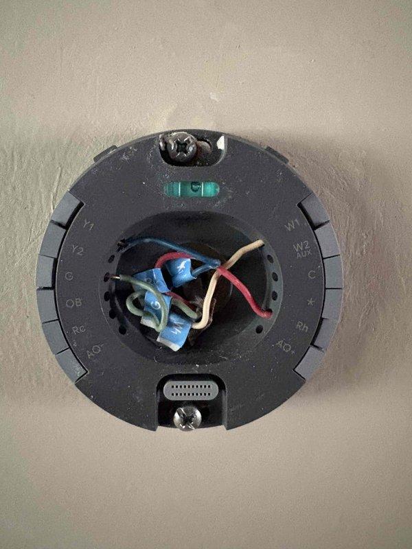 Responded to service call for 12-year-old air conditioning system experiencing short cycling, running only 30-60 seconds before shutting down and restarting later. Upon arrival, performed diagnostic evaluation of thermostat wiring and HVAC control board connections. Inspected thermostat mounting base and verified proper wire terminations at Y1, Y2, G, RC, C, and other terminal points. Examined control board in air handler, checking all wire connections at screw terminals and verifying proper seating of wires including communication and power leads. Documented existing wiring configuration at both thermostat and equipment locations. System evaluated for potential causes of short cycling including thermostat malfunction, loose wiring connections, or control board issues. All connections inspected and photographed for service records.