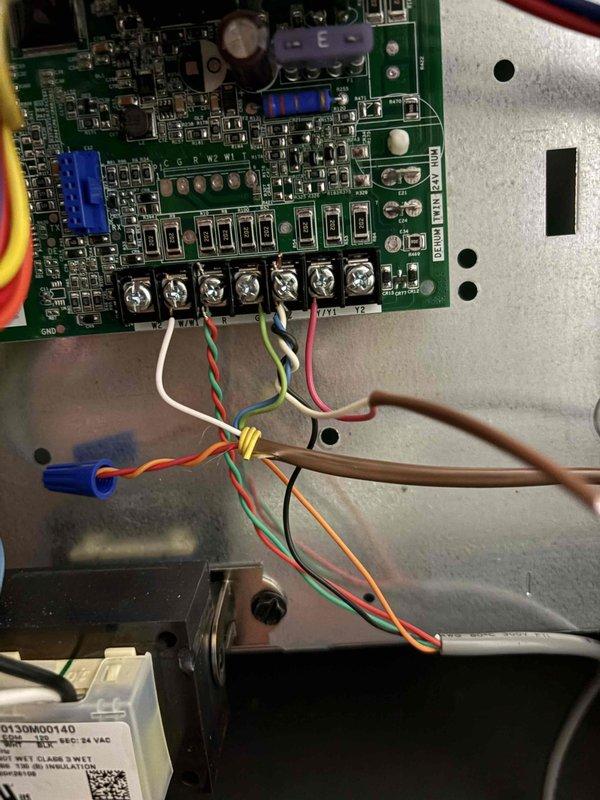 Responded to service call for 12-year-old air conditioning system experiencing short cycling, running only 30-60 seconds before shutting down and restarting later. Upon arrival, performed diagnostic evaluation of thermostat wiring and HVAC control board connections. Inspected thermostat mounting base and verified proper wire terminations at Y1, Y2, G, RC, C, and other terminal points. Examined control board in air handler, checking all wire connections at screw terminals and verifying proper seating of wires including communication and power leads. Documented existing wiring configuration at both thermostat and equipment locations. System evaluated for potential causes of short cycling including thermostat malfunction, loose wiring connections, or control board issues. All connections inspected and photographed for service records.