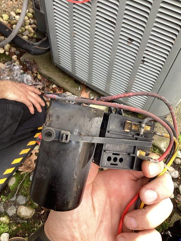 Responded to service call for 16-year-old air conditioning unit experiencing overheating and electrical burning odor. Upon inspection, identified failed dual run capacitor with severe corrosion on terminals and visible deterioration of electrical connections. Removed defective capacitor from condenser unit and replaced with new component to manufacturer specifications. Verified proper wire connections, tested system operation, and confirmed unit running at normal temperatures with no abnormal odors present.