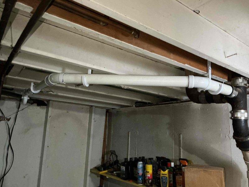 Responded to service call for multiple bathroom issues in older residential property. Assessed and replaced 45-year-old bathroom exhaust fan with customer-supplied unit, ensuring proper electrical connections and ventilation functionality. Inspected leaking copper drain pipe from bathtub to sewer line, identifying multiple small holes requiring repair or replacement. Diagnosed toilet tank fill issue, examining fill valve, flapper assembly, and water supply line to determine cause of improper tank refilling. Documented existing plumbing conditions with photos showing exposed copper piping, drainage systems, and utility area infrastructure for reference and future maintenance planning.