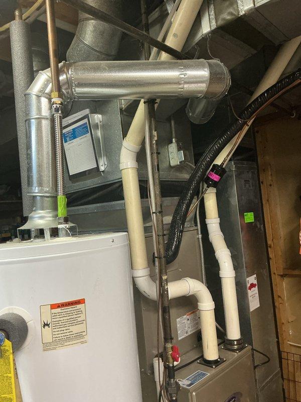 # Water Heater Tune-Up Completed

Performed comprehensive tune-up service on a 12-year-old Craftmaster water heater unit. Conducted thorough inspection of all plumbing connections, including copper supply lines, PVC drainage piping, and flexible braided water supply hoses. Verified proper operation of temperature and pressure relief valve, checked for signs of corrosion or leakage at tank connections, and examined the condition of all pipe insulation throughout the system. Inspected ductwork connections and HVAC integration points in the mechanical room. All components found to be functioning within normal parameters, with system operational and ready for continued service.