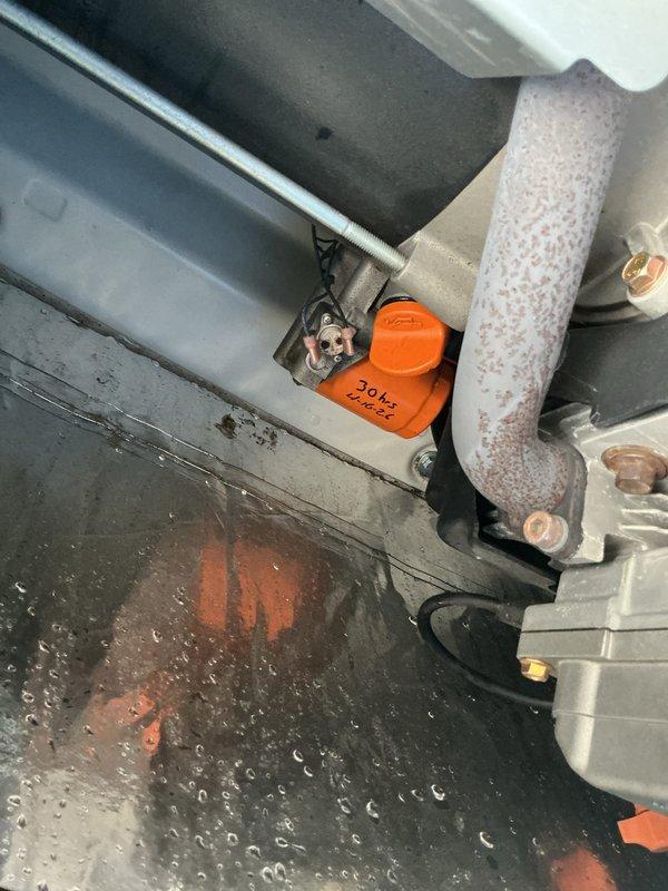 Completed comprehensive 5-year tune-up service on Generac generator unit. Performed standard maintenance protocol including inspection of all major components, motor assembly, and associated mechanical systems. Observed significant water accumulation in condensate collection area with orange safety switch visible among drainage components. Inspected Gould-branded motor unit, copper piping connections with protective caps, heating elements, and associated plumbing connections. Verified all specification labels and compliance plates remain legible and properly affixed. Unit exterior and accessible components showed good overall condition with no major deterioration noted. All standard maintenance tasks completed per manufacturer specifications for 5-year service interval.