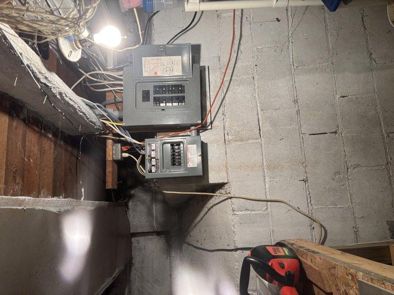 Completed full HVAC system installation including new furnace, air conditioning system, and water heater at residential property. Installed outdoor AC disconnect box with proper electrical connections and conduit routing on exterior wall, and mounted electrical service panels in basement utility area with appropriate circuit protection and wiring. All equipment installed per manufacturer specifications, electrical connections verified, and systems tested for proper operation.