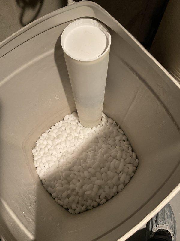 Responded to service call for RainSoft water softener and purification system verification in 20-year-old home where functionality concerns existed for past 3 years. Inspected dual-tank water treatment system in basement, including brine tank and resin tank with control head, confirmed proper plumbing connections via copper and PEX piping throughout house. Verified salt level in brine tank appeared adequate with visible salt pellets present for regeneration cycle.