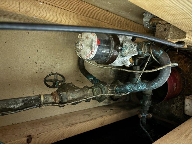Completed annual cooling system tune-up and maintenance on EnergiAir unit. Upon inspection, discovered active water heater leak with severely corroded plumbing components showing heavy oxidation, rust deterioration, and mineral deposits on copper piping and fittings. Documented conditions with photos and advised customer of urgent need for water heater and associated plumbing repairs due to advanced corrosion and active leak posing risk of water damage.