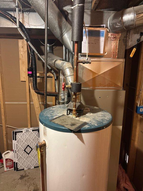 Completed full HVAC system installation in residential basement utility room, including new Carrier furnace unit and air conditioning system with associated ductwork and refrigerant lines. Installed silver flexible ductwork, insulated supply lines, and black refrigerant line sets with proper insulation wrapping. All components properly secured, labeled, and tested for operational functionality. System commissioned and verified for proper airflow and refrigerant charge levels.
