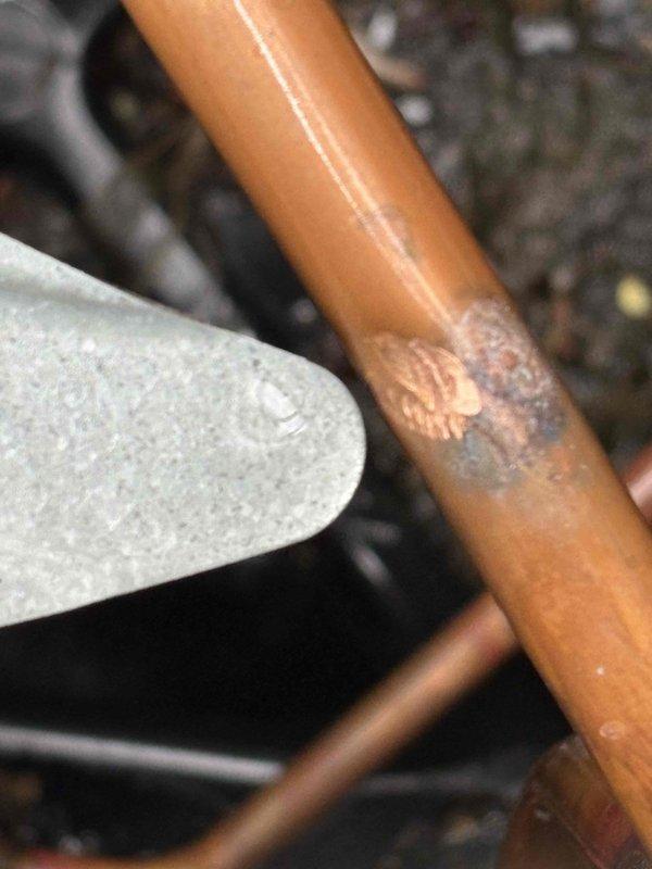 Responded to no-cooling complaint on 9-year-old residential air conditioning system. Upon arrival, found outdoor condensing unit running but fan motor not operating, creating abnormal noise. Breaker had been shut off by homeowner prior to arrival. Inspection revealed significant corrosion and deterioration on refrigerant line, indicating potential leak and system contamination. Condenser fan motor failure confirmed as primary issue preventing proper heat rejection and cooling capacity. Unit requires fan motor replacement and refrigerant line repair to restore normal operation.