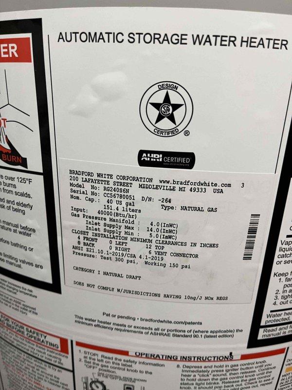 Successfully installed a 40-gallon Bradford White natural gas water heater, model BG240T6N3, with Category 1 natural draft venting in basement utility area. Connected gas supply line, water inlet and outlet piping, installed metallic exhaust vent connector with proper clearances per manufacturer specifications (12" top clearance, 1" vent connector clearance), and verified all connections for proper operation and safety compliance.