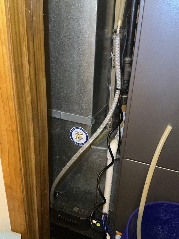 Responded to cooling system refrigerant leak concern at residential property. Upon inspection, identified leaking Schrader valve core on refrigerant line near furnace installation. Removed defective valve core and installed new replacement component. Verified system integrity and proper seal. Unit restored to normal operation with no further refrigerant loss detected.