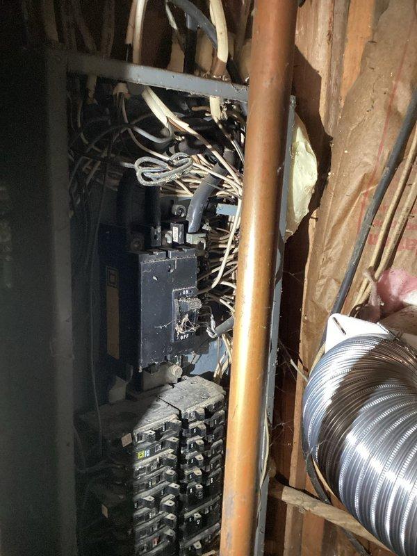 Conducted comprehensive site assessment for whole home electrical upgrade estimate. Documented existing electrical infrastructure including main service panel with exposed circuit breakers, multiple branch circuit wiring, and current electrical distribution system installed within unfinished areas. Photographed electrical panel configuration showing existing breaker arrangement, wire routing, and panel condition to evaluate capacity and compliance requirements. Assessed installation environment including proximity to plumbing lines, HVAC ductwork, and structural framing to determine scope of work needed for complete electrical system modernization and code compliance upgrades.