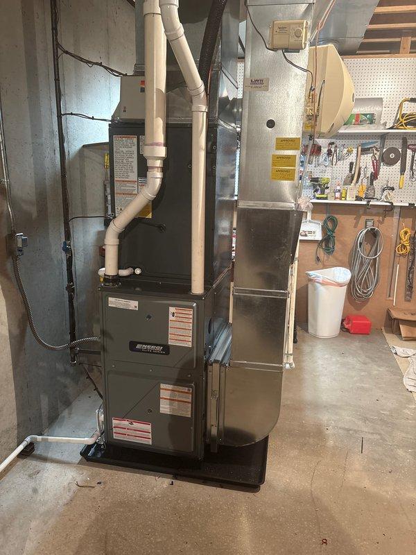 Completed full system replacement of residential furnace and air conditioning unit. Indoor furnace installed in basement mechanical room with proper venting, condensate drainage via PVC piping, and connection to existing ductwork. Outdoor AC condenser unit installed on exterior platform with refrigerant lines, electrical connections via Intermatic disconnect box, and proper copper line set routing. All components tested and operational, system commissioned and ready for service.