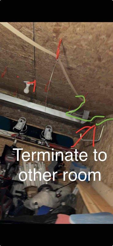 # CP-Cooling Problem

Responded to service call for non-operational air conditioning unit in a home with two systems. The affected unit was a 19-year-old Carrier system with the companion unit still functioning properly. Upon inspection, accessed attic space to evaluate electrical connections and wiring routing to the condensing unit. Photographed wiring configuration showing electrical runs between joists with notation regarding circuit termination to adjacent room. Examined outdoor condensing unit nameplate which displayed significant weathering and debris accumulation, indicating the age and outdoor exposure of the equipment. Documented unit specifications including refrigerant type (R410A), electrical requirements, and AHRI certification information from the weathered data plate for service records and potential replacement recommendations.