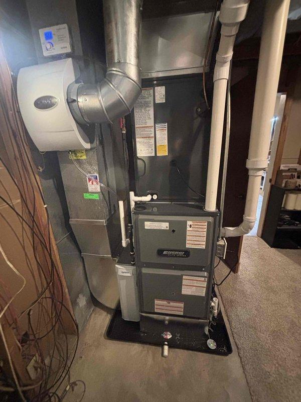 Completed full HVAC system installation including new furnace unit and outdoor air conditioning condenser. Installed Aprilaire whole-house humidifier with digital control panel, connected all ductwork and PVC condensate piping, and mounted exterior condenser unit on concrete pad with proper electrical connections. System tested and verified operational with all components functioning per manufacturer specifications.