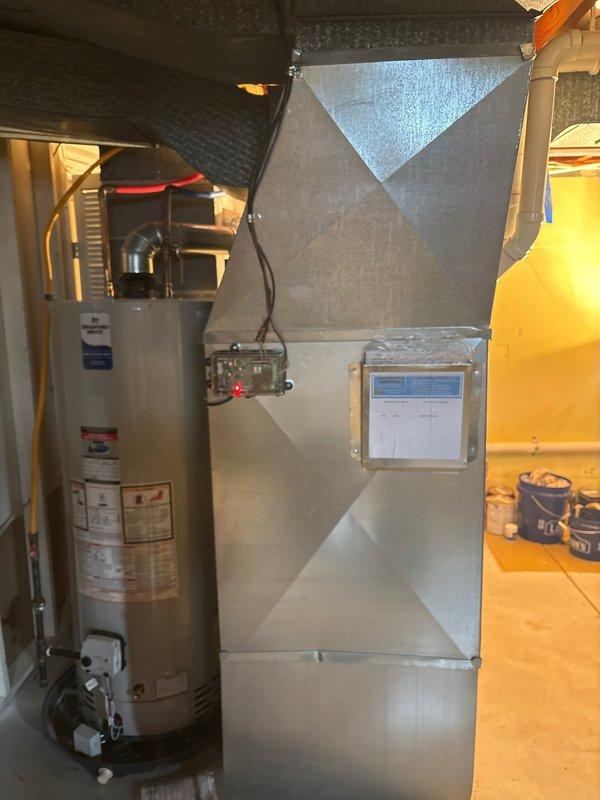 Completed installation of new air conditioning system in residential basement utility area. Installed furnace unit with PVC condensate drainage routing, integrated with existing water heater and plumbing infrastructure. Verified proper ductwork connections, tested system operation, and confirmed all mechanical components functioning within manufacturer specifications.