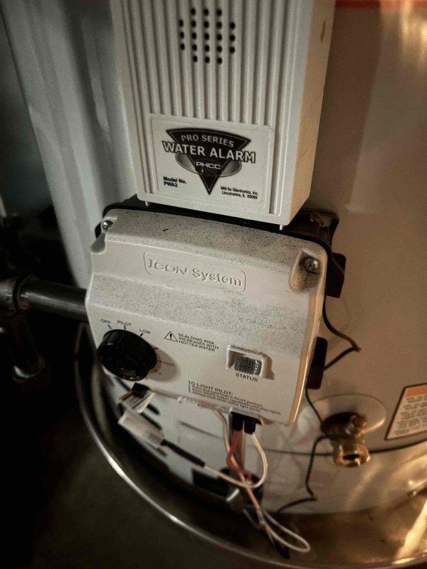 Responded to no hot water complaint at residential property. Upon arrival, accessed property using provided entry code. Inspected water heater system and found ICON System control unit operational with PRO SERIES water alarm properly mounted. Verified all plumbing connections, copper supply lines, and venting components were secure and functioning correctly. Tested hot water delivery and confirmed system restored to full operation. Documented installation with photographs showing control unit, safety devices, and overall equipment condition.