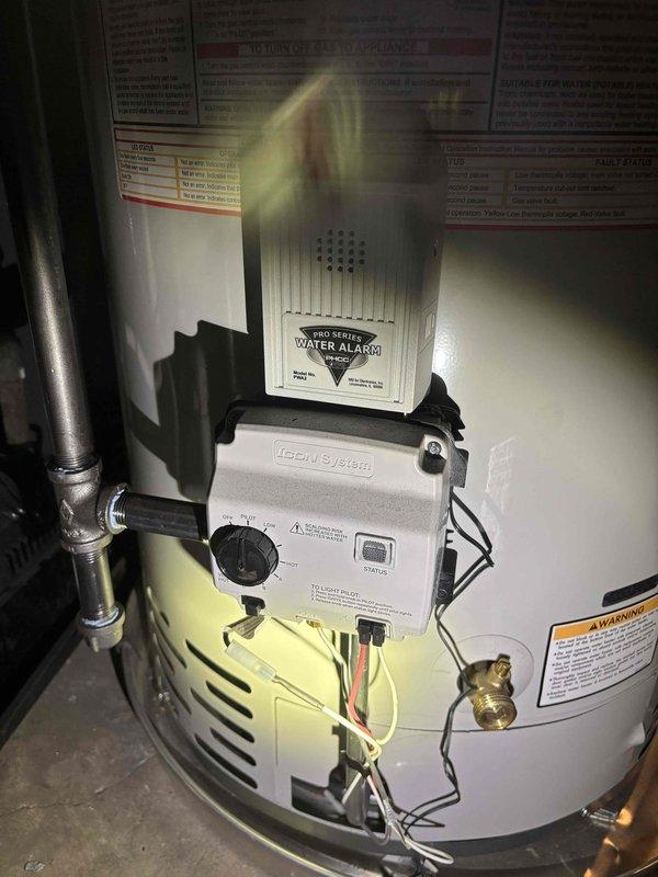 Responded to no hot water complaint at residential property. Upon arrival, accessed property using provided entry code. Inspected water heater system and found ICON System control unit operational with PRO SERIES water alarm properly mounted. Verified all plumbing connections, copper supply lines, and venting components were secure and functioning correctly. Tested hot water delivery and confirmed system restored to full operation. Documented installation with photographs showing control unit, safety devices, and overall equipment condition.