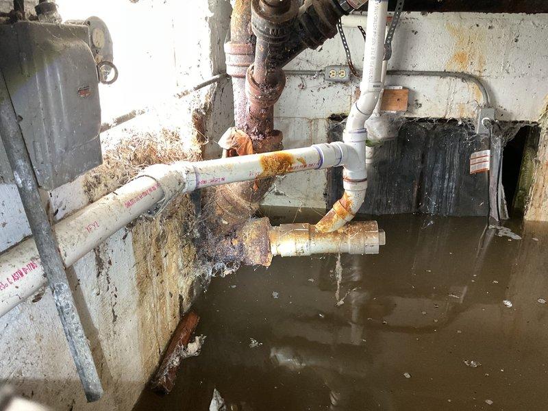 Responded to emergency water leak in crawlspace with active flooding and standing water throughout the space. Upon arrival, discovered severely corroded metal piping with compromised integrity and extensive rust damage, along with deteriorated plumbing infrastructure showing signs of recent disturbance potentially related to prior plumbing work. Documented extensive water damage to concrete block walls including rust staining, mold growth, and moisture intrusion patterns indicating prolonged exposure. Assessed PVC and metal piping systems, noting advanced corrosion on metal pipes and multiple connection points requiring attention. Photographed conditions for insurance documentation and recommended immediate water extraction, pipe repair or replacement of corroded sections, mold remediation, and structural assessment of water-damaged walls.