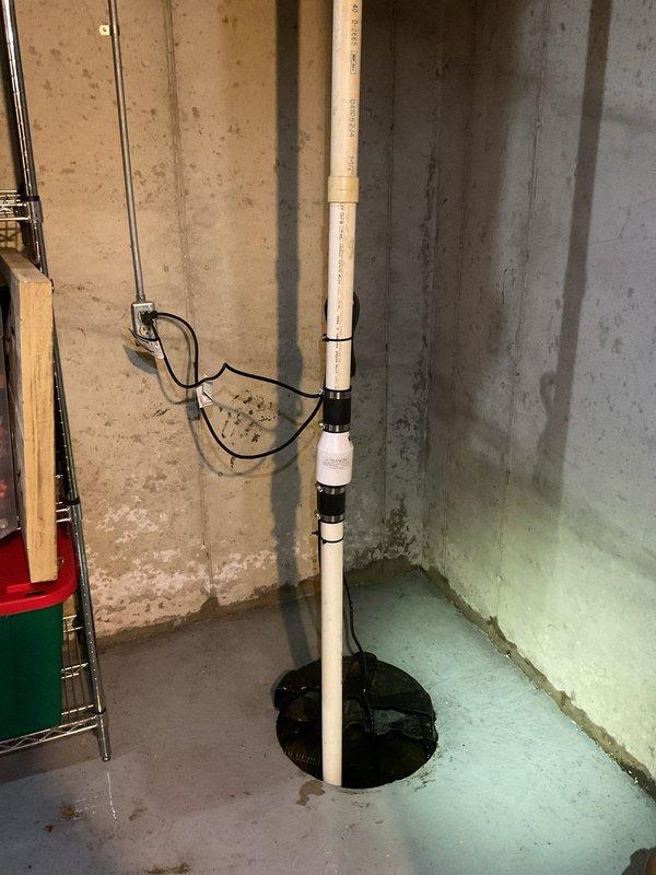 Responded to emergency call for sump pump actively flooding basement. Upon arrival, assessed the sump pit and pump system located in basement corner. Pump had failed, causing water accumulation and active flooding condition. Removed and replaced malfunctioning sump pump unit with new equipment. Installed pump in existing sump basin with proper discharge piping through vertical PVC system. Verified electrical connections were secure and properly grounded to wall-mounted outlet. Tested pump operation through multiple cycles to ensure proper float activation and discharge flow. Confirmed all water was evacuated from basement floor and pit was functioning correctly. System restored to full operational status with no further flooding observed.