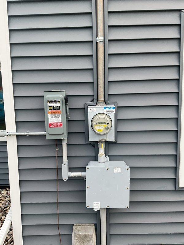 Conducted comprehensive electrical assessment of owner-occupied single-family residence originally constructed in 1920 with two subsequent additions. Evaluated existing electrical service infrastructure, including exterior meter base, disconnect, and interior main distribution panel mounted in basement utility area. Documented current panel configuration showing overloaded conditions with insufficient breaker capacity to safely accommodate existing electrical loads and future expansion needs. Photographed exterior service equipment including weatherhead, meter socket, and disconnect switch, as well as interior panel installation with multiple circuits and conductor routing. Prepared detailed electrical estimate for panel upgrade to address code compliance and capacity requirements for 106-year-old residential structure with modified electrical system.