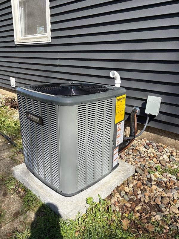 Completed full HVAC system replacement including outdoor condensing unit and indoor air handler/furnace. Outdoor unit installed on existing concrete pad with proper electrical disconnect, condensate drain lines, and refrigerant line connections. Indoor equipment positioned in basement utility area with new ductwork connections, PVC condensate drainage, and proper clearances maintained per manufacturer specifications.