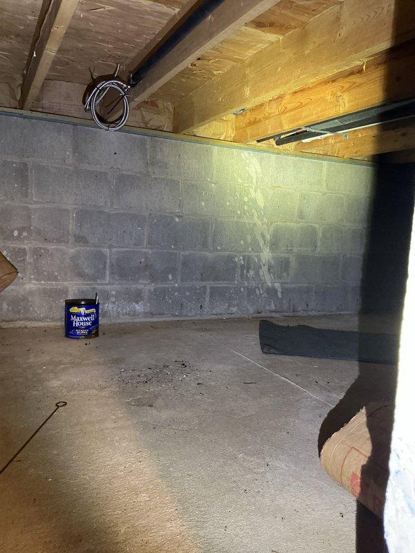 Installed new sump pump system in unfinished basement crawl space per customer request. System installed and operational, with discharge piping routed through floor joists to appropriate exterior drainage point.