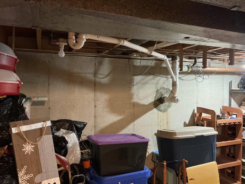 Installed new sump pump system in unfinished basement crawl space per customer request. System installed and operational, with discharge piping routed through floor joists to appropriate exterior drainage point.