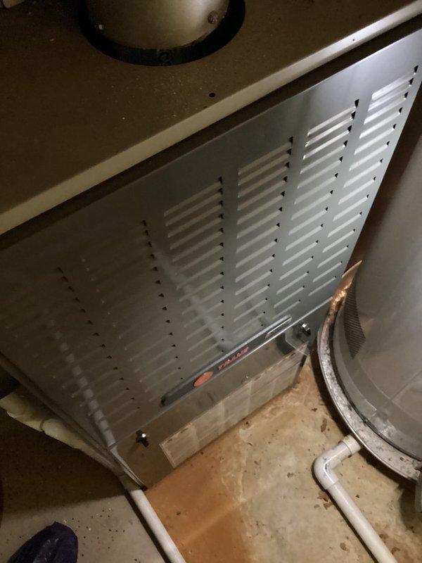 # No Heat Service Call

Responded to a no heat call for a furnace that was not turning on. Upon arrival, inspected a Goodman furnace model RCF361Z7STAVUA, serial number W271G37799, manufactured in 2012 (approximately 10 years old). Unit is installed in basement mechanical room alongside water heater. Documented equipment identification and installation condition with photos for service records. Furnace cabinet and surrounding area showed normal wear for age with dust accumulation at base typical of basement installation.