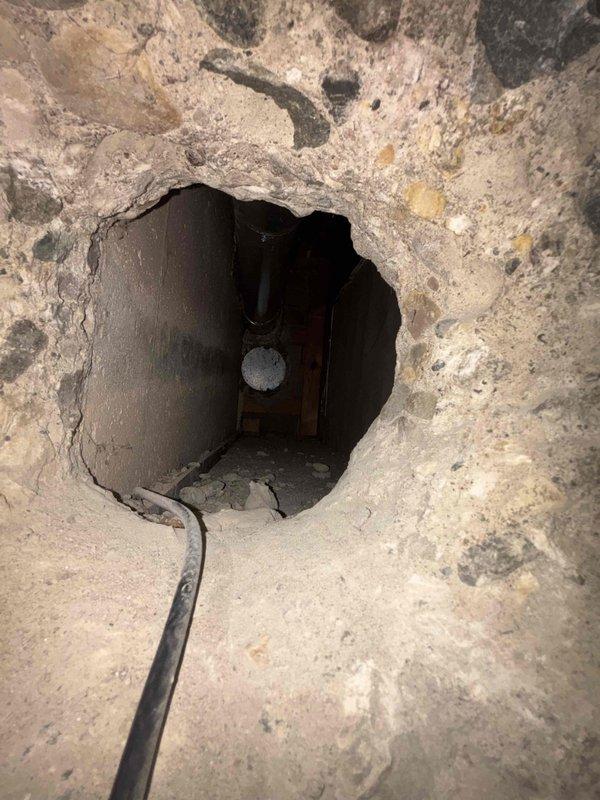 Completed water heater installation in basement utility area. Installed new white cylindrical water heater unit with proper metallic exhaust vent piping extending to ceiling for safe combustion gas ventilation. Connected all necessary plumbing lines including hot and cold water supply lines with appropriate valves and fittings at base of unit. Secured all copper piping connections and verified proper clearances around unit for safety and code compliance. Ensured all manufacturer specifications and regulatory requirements were met during installation. Tested unit operation and confirmed proper venting system function. Work area left clean and operational.