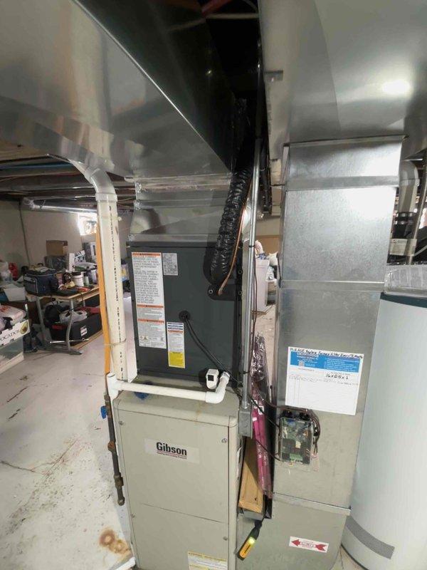 Completed full HVAC system replacement including installation of new Gibson air handler unit in basement utility room with associated ductwork connections and refrigerant line integration. Installed outdoor condensing unit with proper refrigerant charging per manufacturer specifications, documenting factory charge of 52.4 oz, field charge of 6.0 oz, for total system charge of 59.4 oz of A2L refrigerant. System commissioned, tested, and left in operational condition with all electrical connections, ductwork, and controls verified functional.