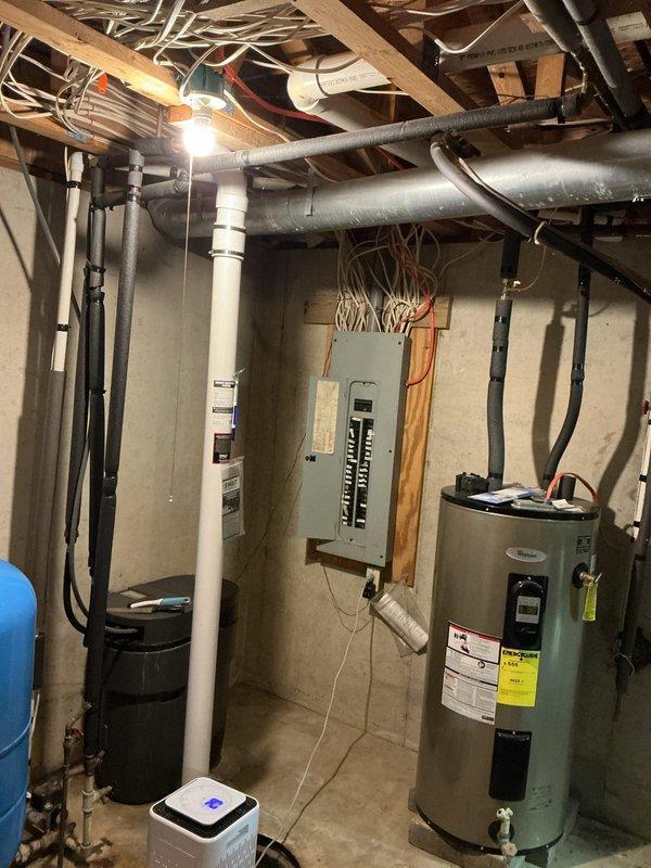 Completed installation of whole-house water softener system in thirty-year-old residential property per quote provided one year prior. System was installed in basement utility area adjacent to existing water heater and pressure tank, with all plumbing connections made to integrate softener into main water supply line. Installation included proper placement of equipment, connection of supply and discharge lines, and verification of system operation upon completion.