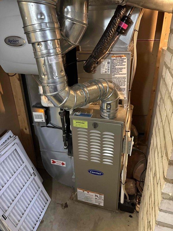 Completed full air conditioning system installation including outdoor condenser unit mounted on concrete pad and connected to existing Carrier furnace with integrated ductwork in basement. Installed all necessary refrigerant lines, electrical connections, and condensate drainage, with system tested and verified operational. Michigan Saves financing documentation processed through DocuSign for customer approval.