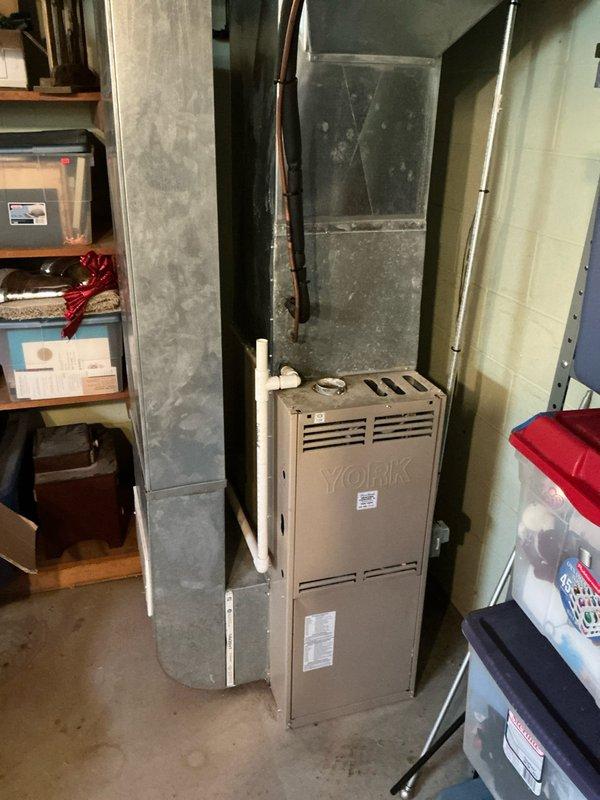 Conducted sales estimate for air conditioning system replacement on 15-year-old York HVAC unit currently serving residential property. Inspected existing furnace and boiler system installation in basement utility area, documented equipment specifications, and photographed current system configuration including ductwork, piping connections, and mechanical components to provide accurate replacement proposal for aging but currently functional air conditioning system.