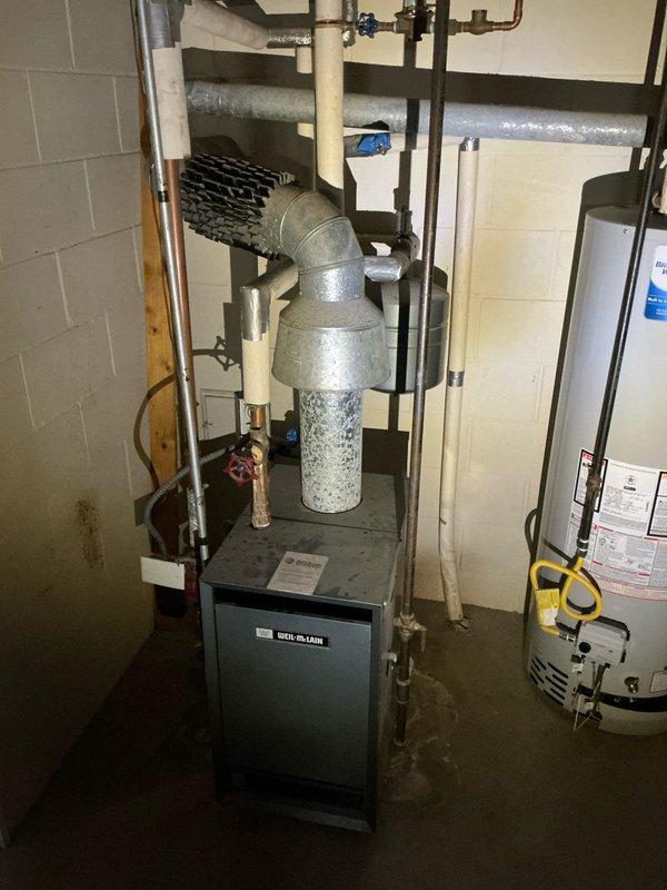 Conducted sales estimate for air conditioning system replacement on 15-year-old York HVAC unit currently serving residential property. Inspected existing furnace and boiler system installation in basement utility area, documented equipment specifications, and photographed current system configuration including ductwork, piping connections, and mechanical components to provide accurate replacement proposal for aging but currently functional air conditioning system.