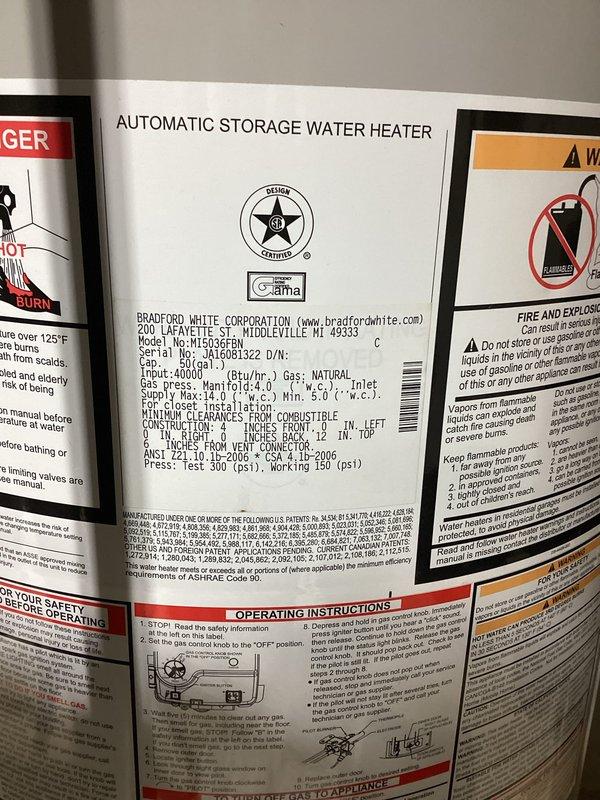 Responded to service call for Bradford White water heater model M150S6FN with reports of potential leak and no hot water production. Upon inspection, discovered significant rust and corrosion visible through the ventilation grille at the base of the unit, indicating internal deterioration and compromised structural integrity. The oxidation patterns and discoloration suggest prolonged moisture exposure and potential tank failure. Documented the unit's condition including manufacturer specifications showing 40,000 BTU/hr natural gas input rating. Verified all safety labels and operational warnings were intact and legible. Photographed evidence of corrosion for service records and provided assessment of unit condition to determine necessary repairs or replacement recommendations.