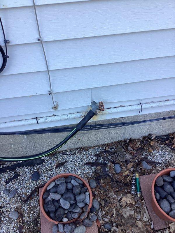 Replaced outdoor spigot at exterior wall of residence. Removed existing frost-free hose bib and installed new quarter-turn ball valve spigot with proper mounting to ensure secure attachment to structure and prevent future leaks.