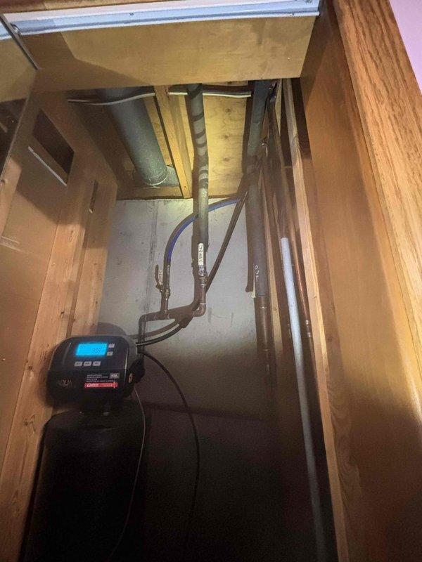 Responded to service call for water softener requiring new filter installation on a nine-year-old unit affecting whole-house water quality for approximately twenty days. Accessed water softener system located in interior utility closet with digital control head, inspected existing filtration components and plumbing connections, and documented equipment condition and installation area. Evaluated system performance and completed necessary filter replacement to restore proper water treatment throughout the residence.
