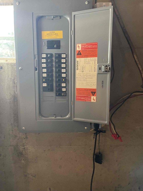 Conducted on-site evaluation for new air conditioning system installation in residential property without existing HVAC equipment. Assessed electrical service capacity and panel configuration in basement utility area, documented existing 200-amp service with available breaker spaces for new AC equipment connection. Photographed electrical infrastructure and measured clearances around service panels to determine equipment placement requirements and verify adequate space for installation of condensing unit, air handler, and associated electrical disconnects per code requirements.