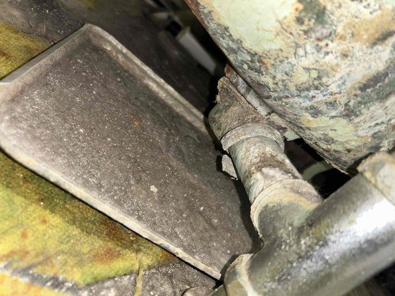Responded to plumbing leak complaint regarding tub drain. Upon inspection, discovered deteriorated conditions in mechanical/utility area with evidence of moisture intrusion and water damage to surrounding surfaces and equipment. Documented extensive environmental deterioration including staining, mineral deposits, and compromised finishes on nearby water heater and structural surfaces. Assessed drain line connections and identified source of leak requiring repair to prevent further water damage to basement area.