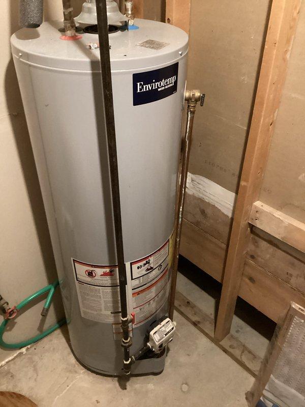 Completed estimate for water heater replacement, upgrading from existing 40-gallon Envirotemp unit to 50-gallon capacity system. Assessed current installation in unfinished basement area, documented existing copper supply line connections, venting configuration, and clearance requirements between wall studs for larger capacity unit installation.