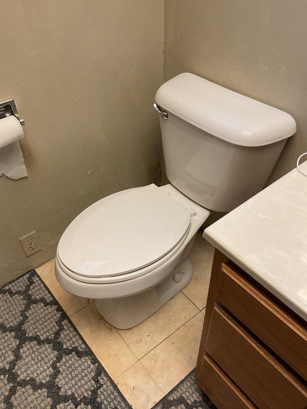 Responded to callback for toilet leak at base in 104-year-old residence. Upon inspection, identified water seepage at toilet base connection related to previous service work. Removed toilet, inspected and replaced wax ring seal, verified flange condition, and reinstalled toilet with proper alignment and secure mounting. Tested flush cycles and confirmed no further leakage at base connection. Documented conditions with photographs for service records.