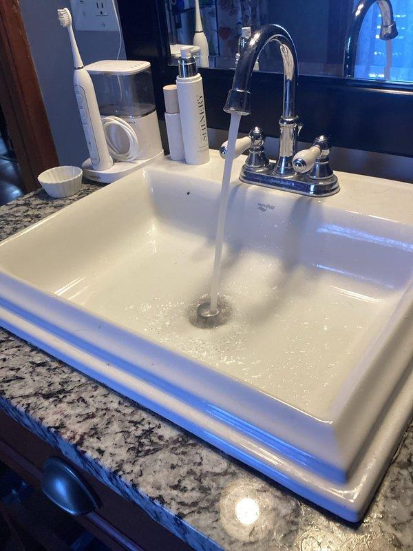 Responded to emergency call for valuable ring dropped down bathroom sink drain. Disassembled P-trap assembly beneath vanity sink to retrieve item and restore drainage function. Successfully recovered ring from trap and reassembled plumbing connections. Tested water flow to confirm proper drainage and verified no leaks at slip joint connections before returning fixture to service.