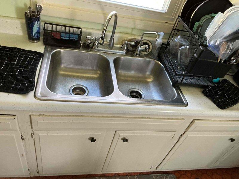 Responded to a kitchen sink clog and drainage issue. Successfully cleared the blockage in the double-basin stainless steel sink using professional drain cleaning equipment, restoring proper water flow and drainage to the fixture.