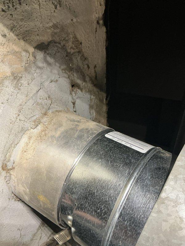 Installed new metallic chimney liner system in residential basement. Routed corrugated flexible duct from existing heating unit through masonry structure, securing proper connection points and ensuring code-compliant venting for HVAC system alongside existing Goodman furnace installation.