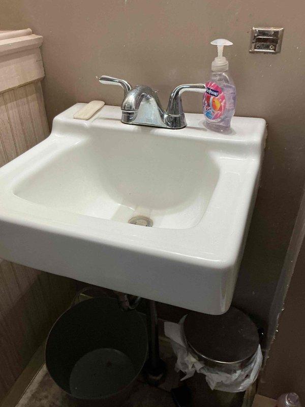 Responded to plumbing leak under bathroom sink that had been active for one day. Upon inspection, identified leak at P-trap connection beneath wall-mounted sink. Tightened drain fittings and verified all connections were properly sealed to stop water drip. Tested system by running water through sink and confirmed leak was resolved with no further dripping present.
