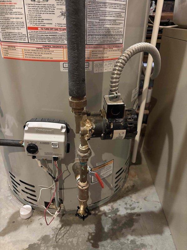 Completed comprehensive tune-up service on dual water heater system with both units exceeding 10 years of age. Performed standard maintenance procedures including inspection of all plumbing connections, copper piping, brass fittings, gas line connections, temperature and pressure relief valves, and Honeywell control unit. Verified proper operation of circulation pump, checked all shut-off valves including red-handled isolation valve, and assessed overall system performance. Both water heaters were inspected for signs of leakage, corrosion, and sediment buildup. Provided customer with pricing information for water softener filtration system as requested.